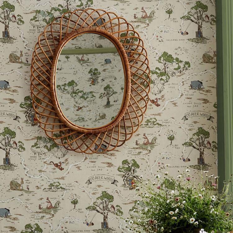 Disney Home x Sanderson Hundred Acre Wood Cashew wallpaper with hand-illustrated woodland scenes featuring Winnie the Pooh and friends in warm neutral tones.