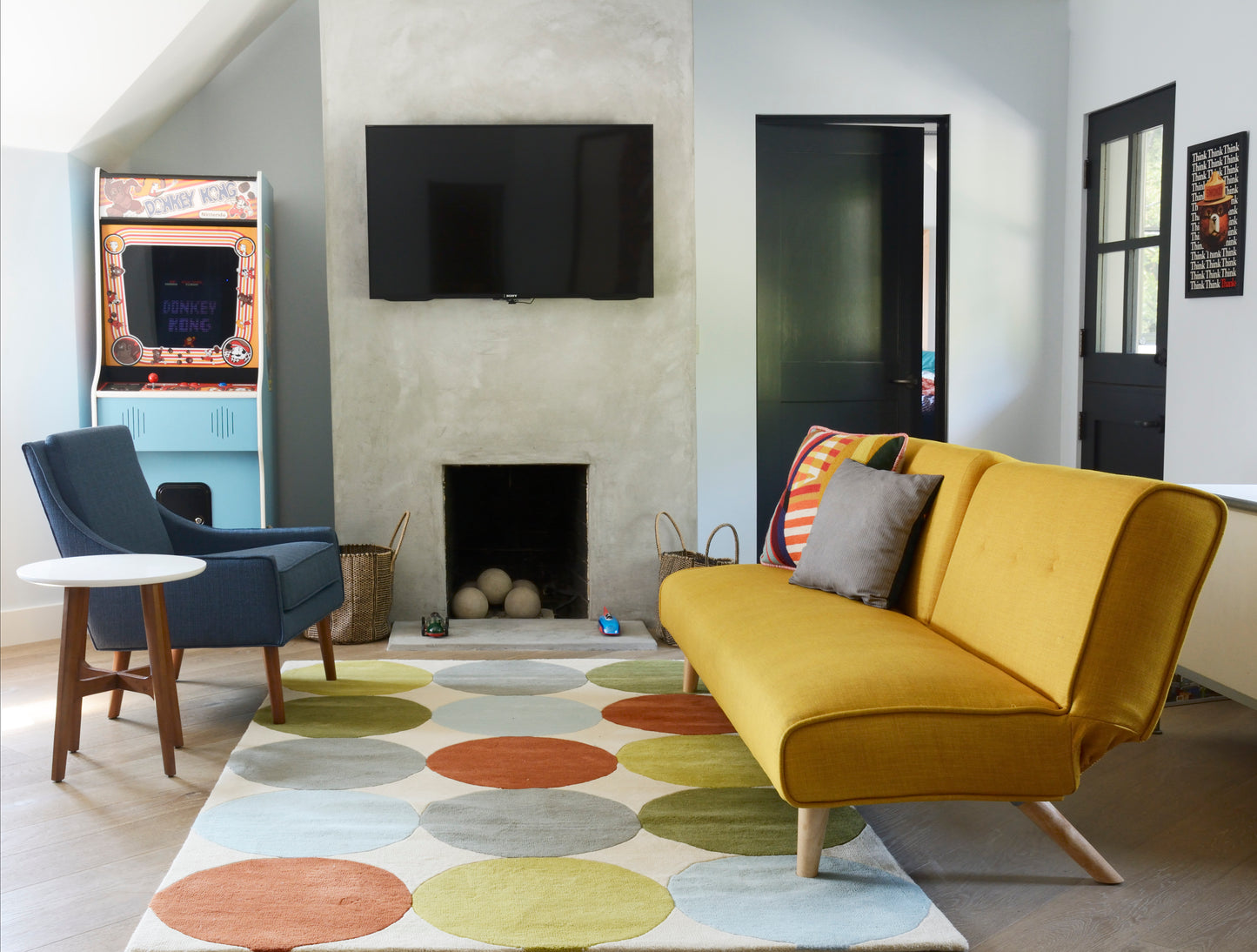 Round multicolor polka-dot rug in a living room setting.