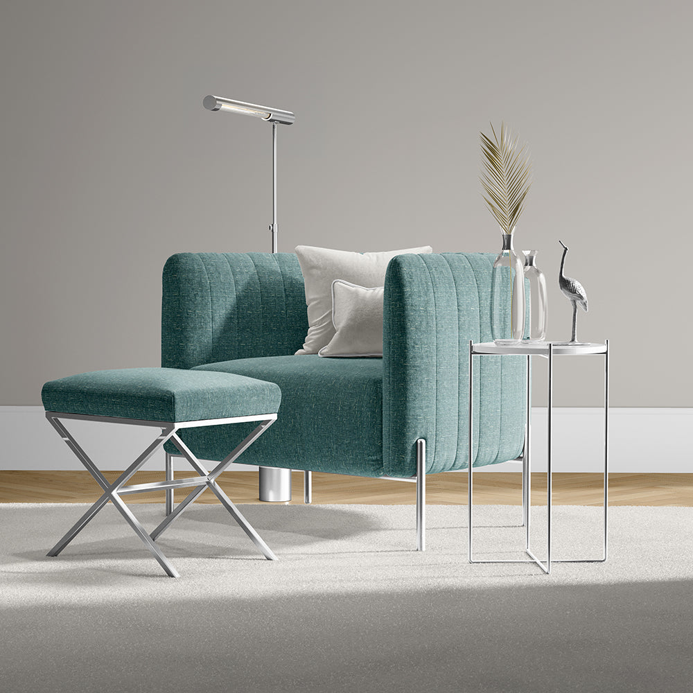 Teal velvet upholstered lounge chair with matching ottoman, chrome-frame glass-top side tables, vase and lamp.