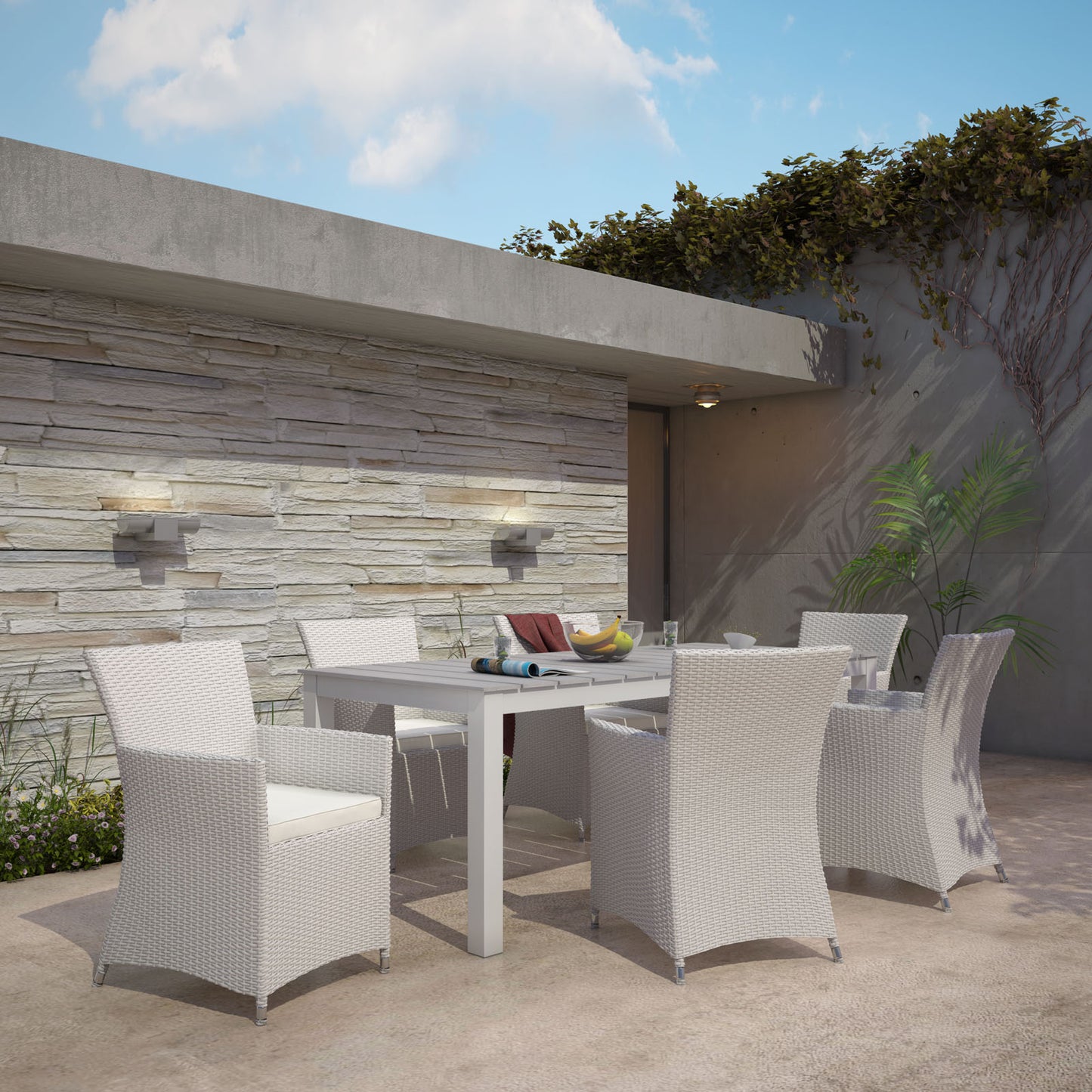 Outdoor gray & white wicker dining set with six chairs around a white rectangular table on a modern patio.