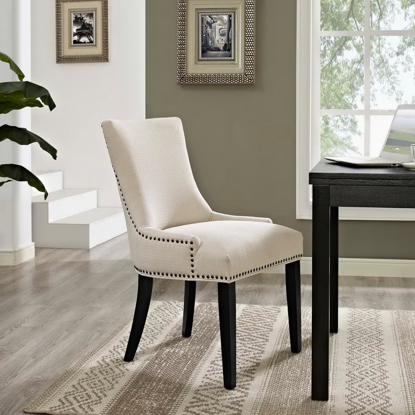 Fabric dining chair with nailhead trim, curved back and black tapered legs