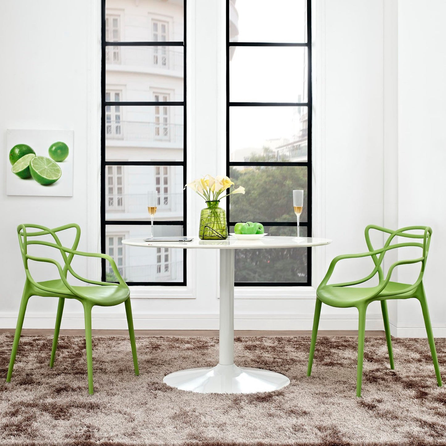 Two green molded dining chairs in a bright modern dining nook.