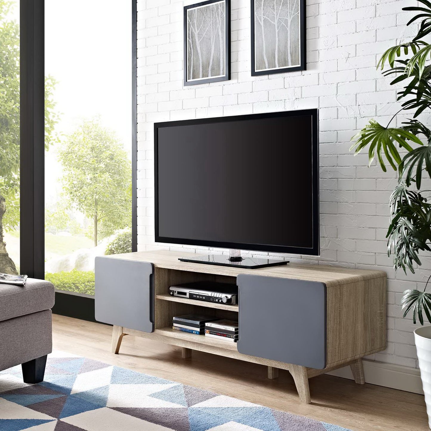 Natural gray TV stand with gray cabinet doors, open middle shelves, and a flat-screen TV in a modern living room.
