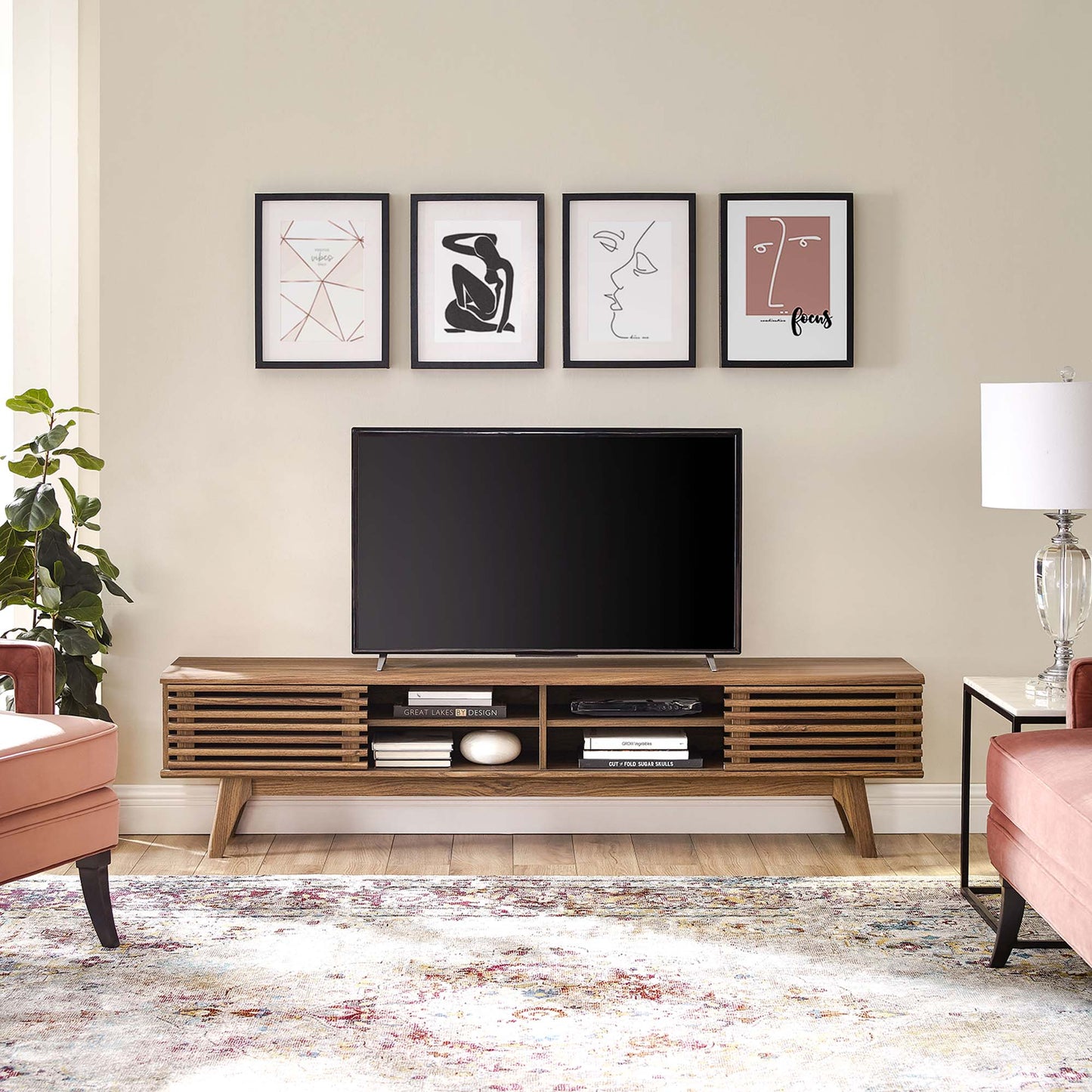 Mid-century walnut TV console with slatted doors, flat-screen TV, shelves of books, line-art above in beige living room