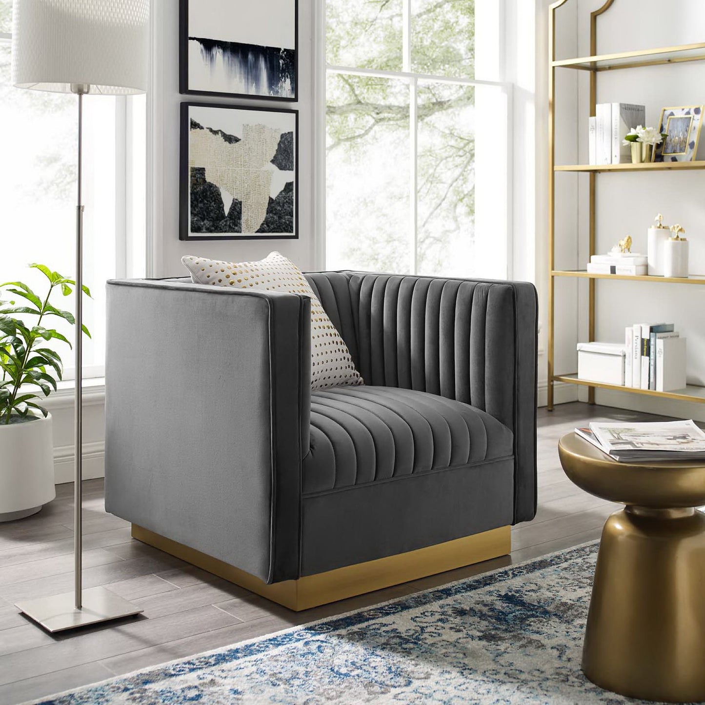 Grey velvet vertical channel-tufted armchair in a bright modern living room.