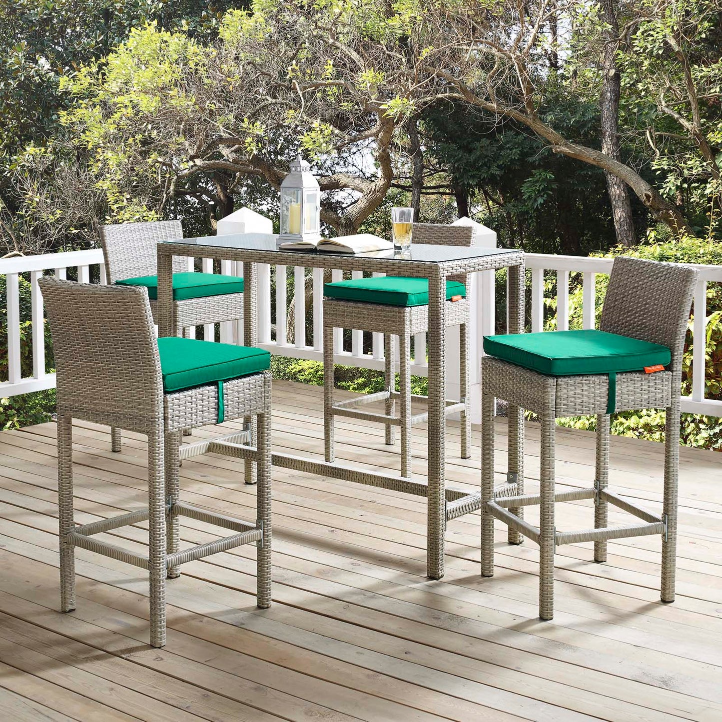 Outdoor wicker rattan bar stools set of 4 with light gray-green cushions on a wooden deck in a garden