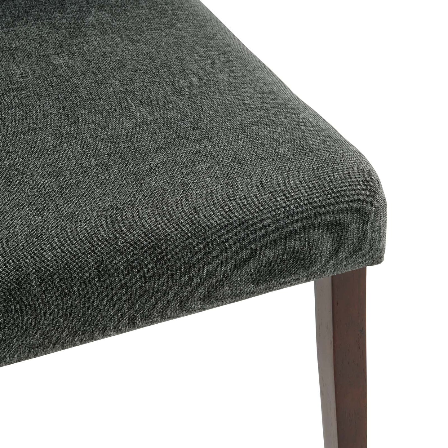 Grey textured fabric upholstered dining side chair with a dark wood tapered leg and curved edge.