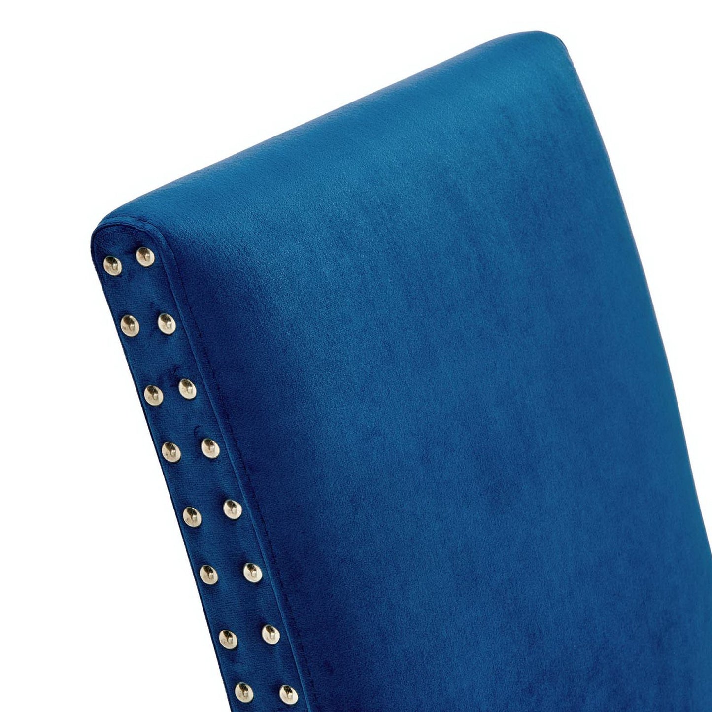 Navy blue velvet dining side chair back with gold nailhead trim along the edge.