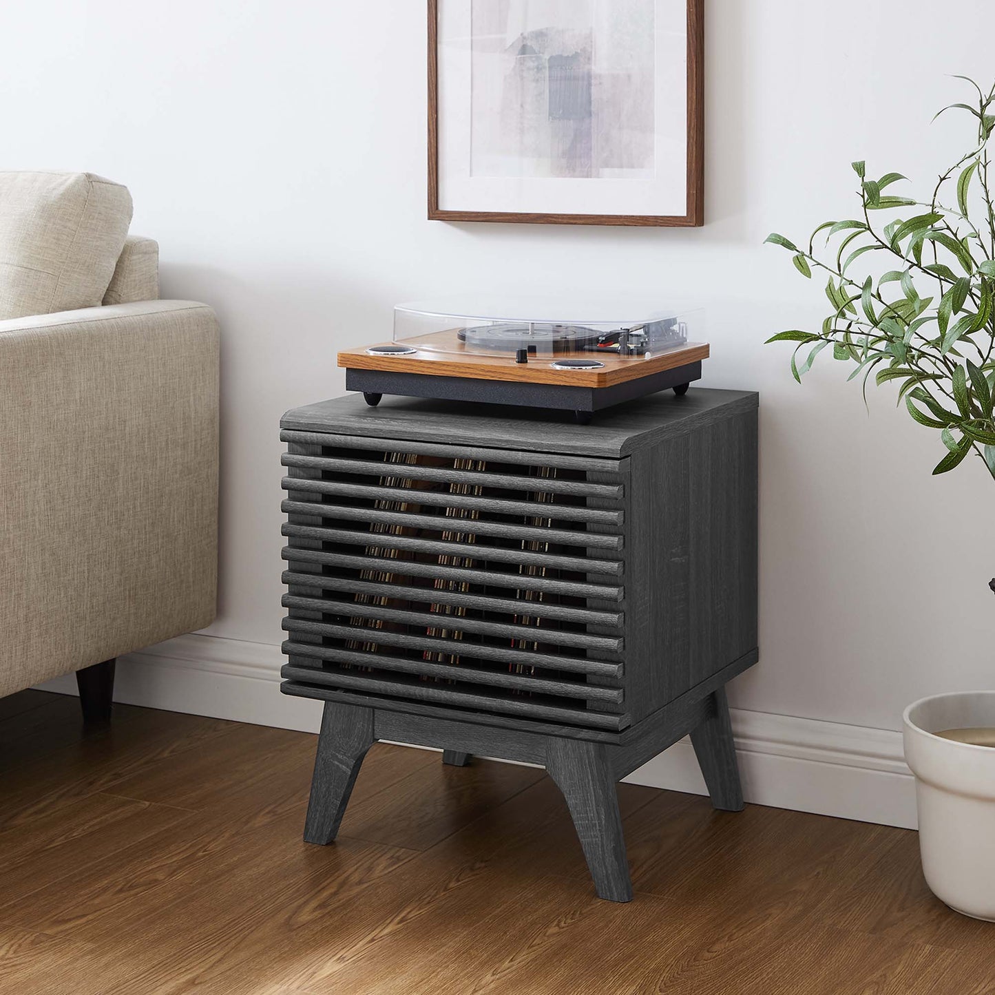 Charcoal gray mid-century vinyl record display stand with angled legs in a living room.
