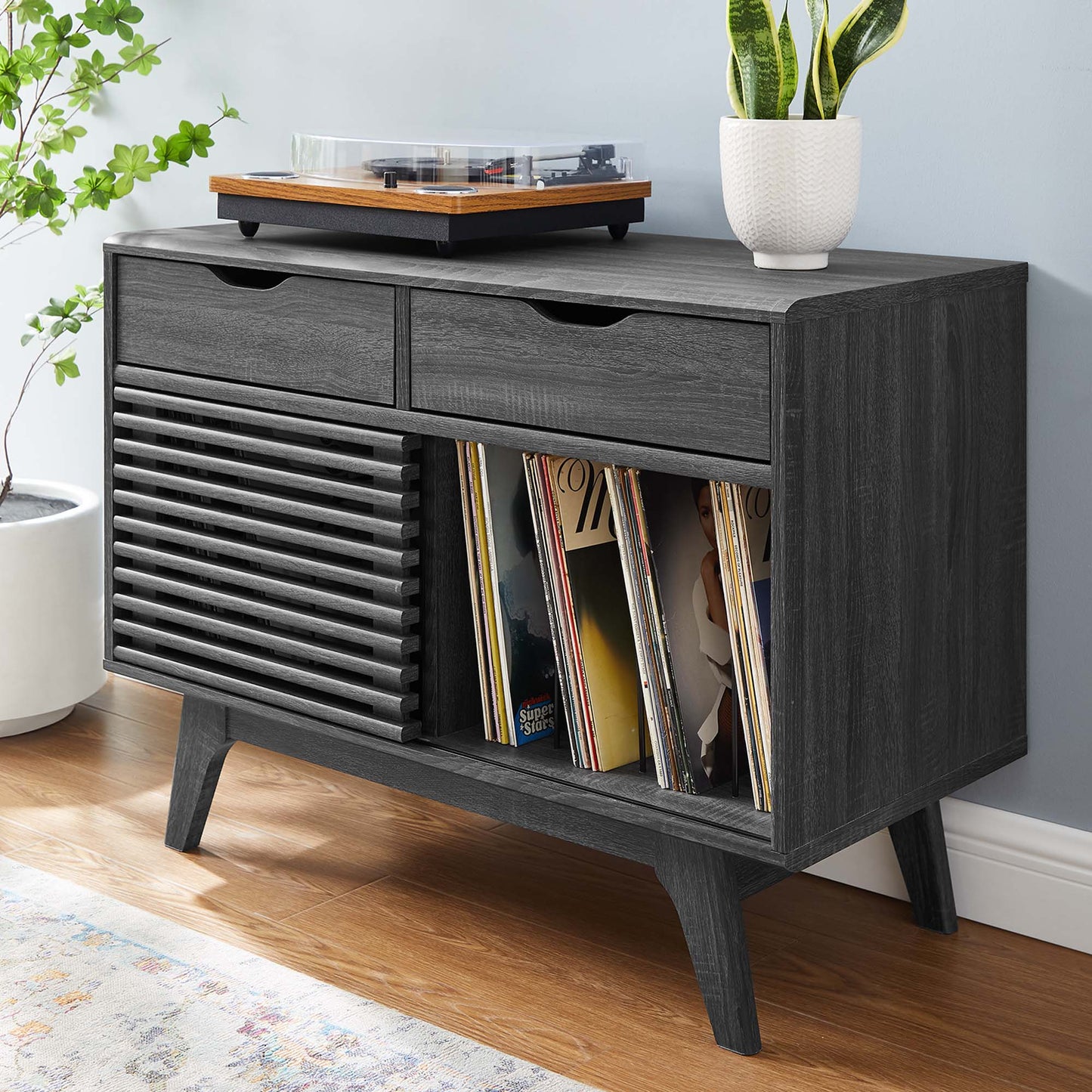 Dark brown vinyl record display stand with slots for records and a top surface