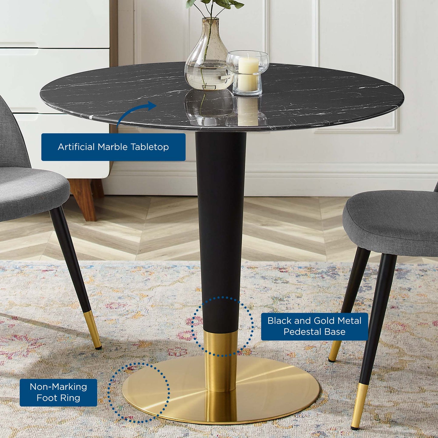 Round black artificial marble tabletop on a black & gold metal pedestal base with a gold foot ring; modern dining table.
