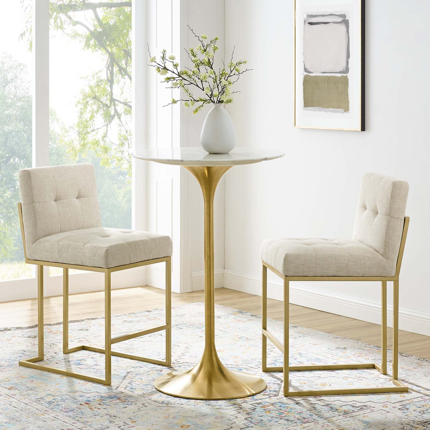 Two brown upholstered fabric counter stools with gold-tone metal frames, part of a modern counter-height dining set.