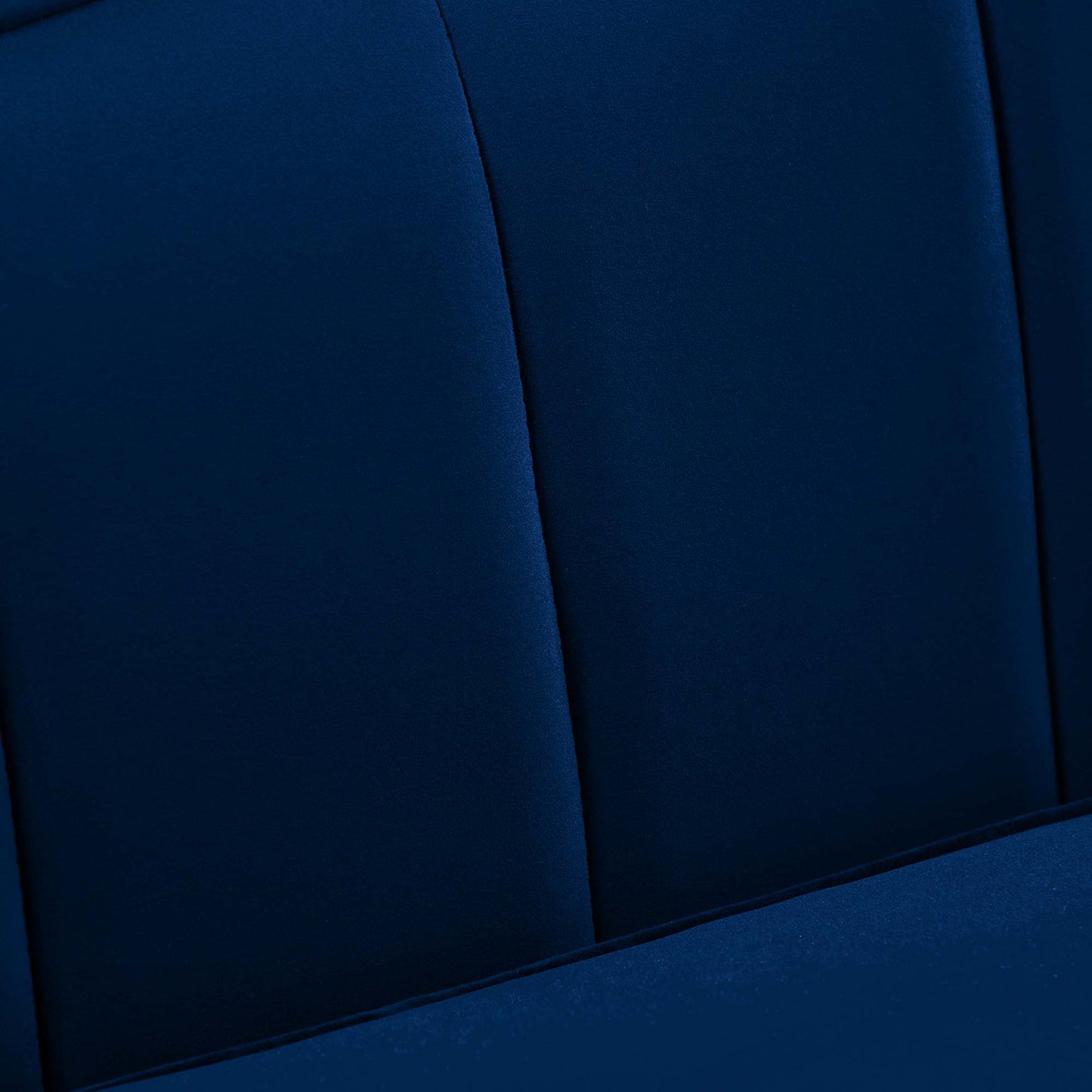 Navy blue performance velvet sofa with channel-tufted back and padded seating.