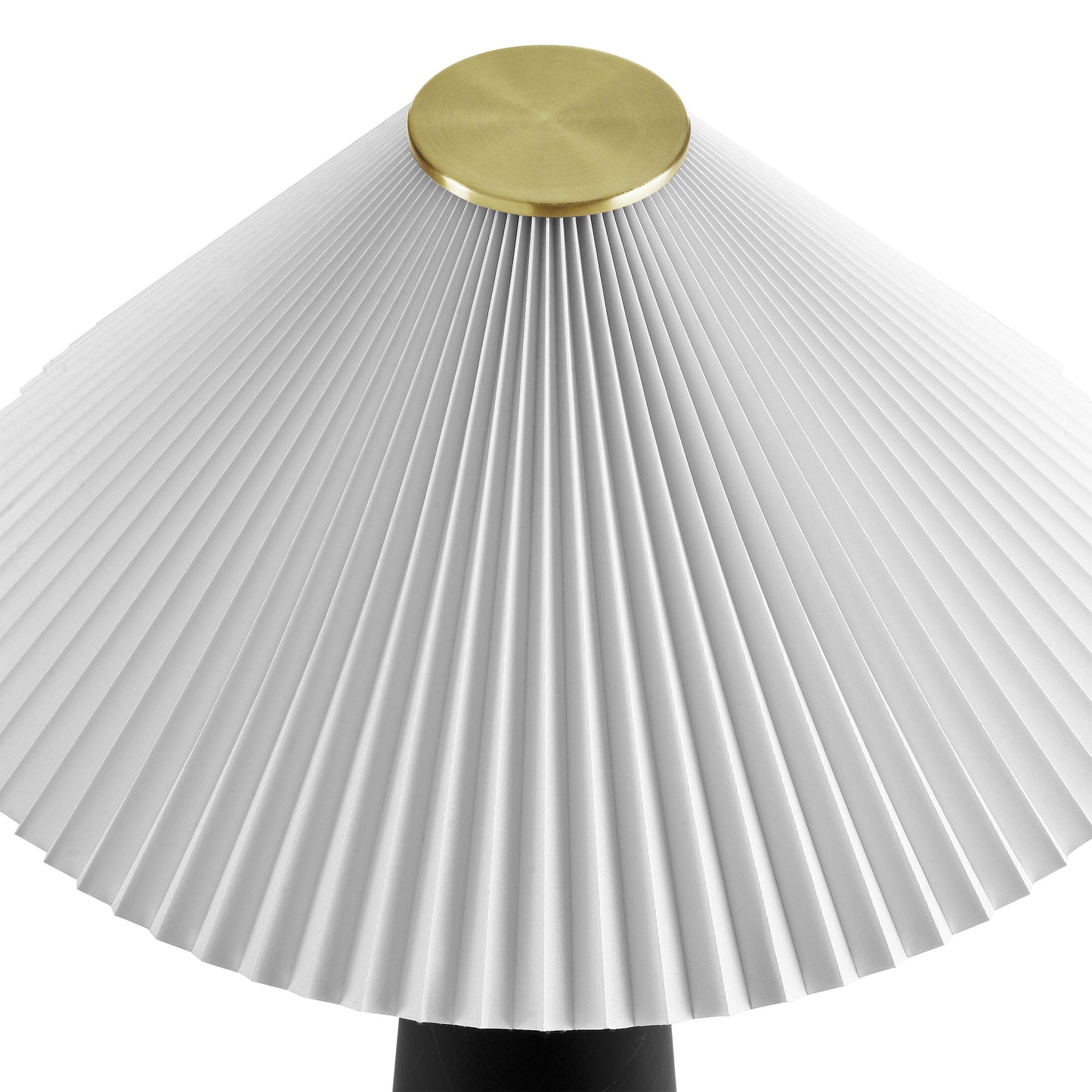 White pleated lampshade with brass cap atop a black table lamp base
