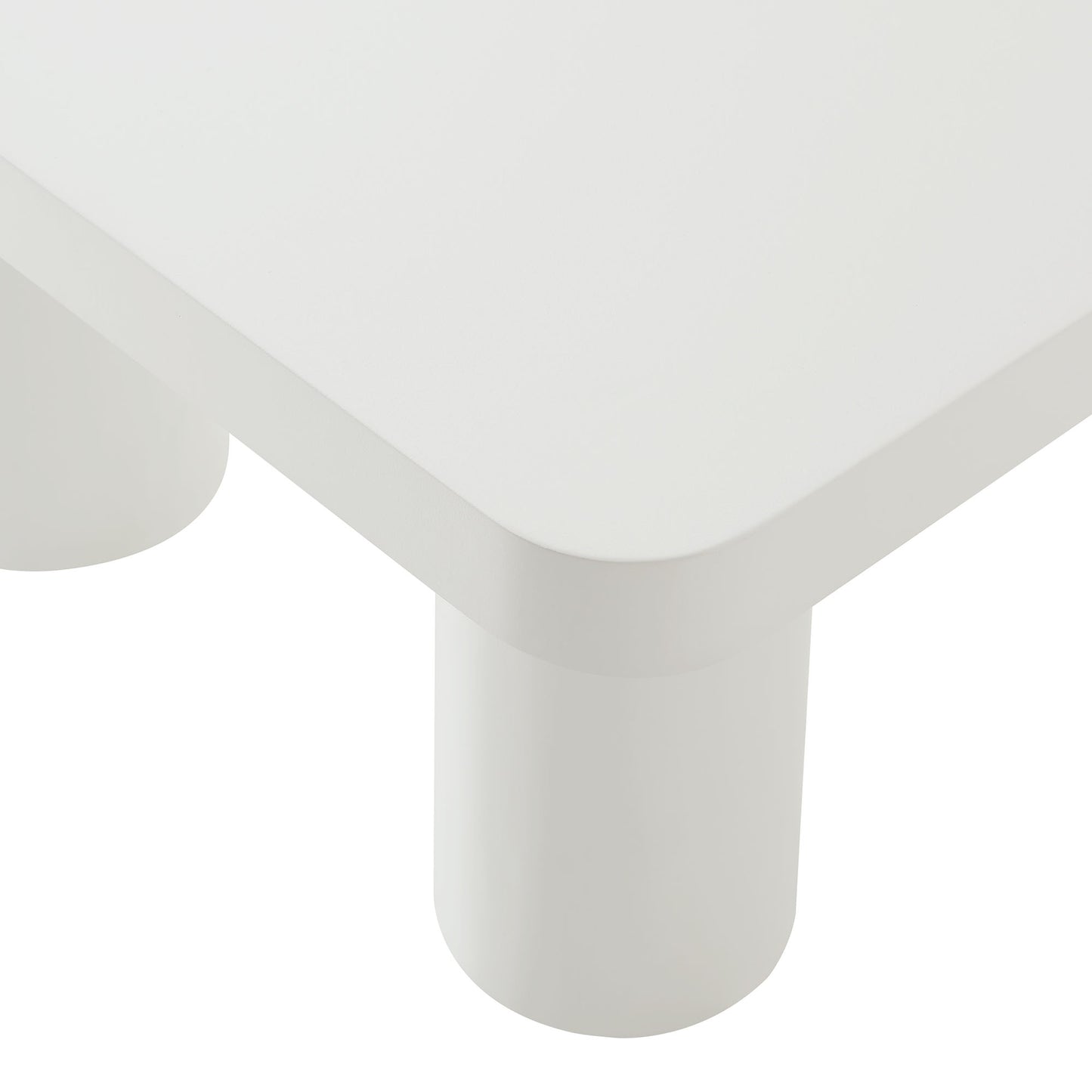 White rectangular coffee table with rounded edges and white cylindrical legs, modern minimalist living room furniture.