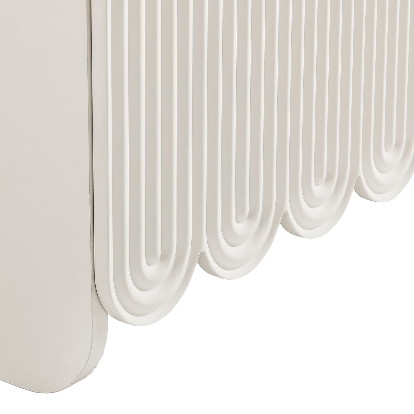 White sideboard storage cabinet with fluted panels and scalloped edges.