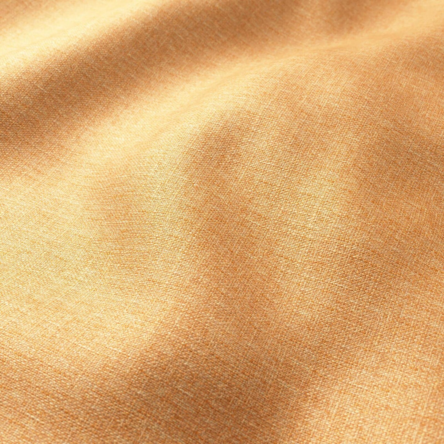 Close-up of peach-orange woven fabric with subtle weave and soft drape.