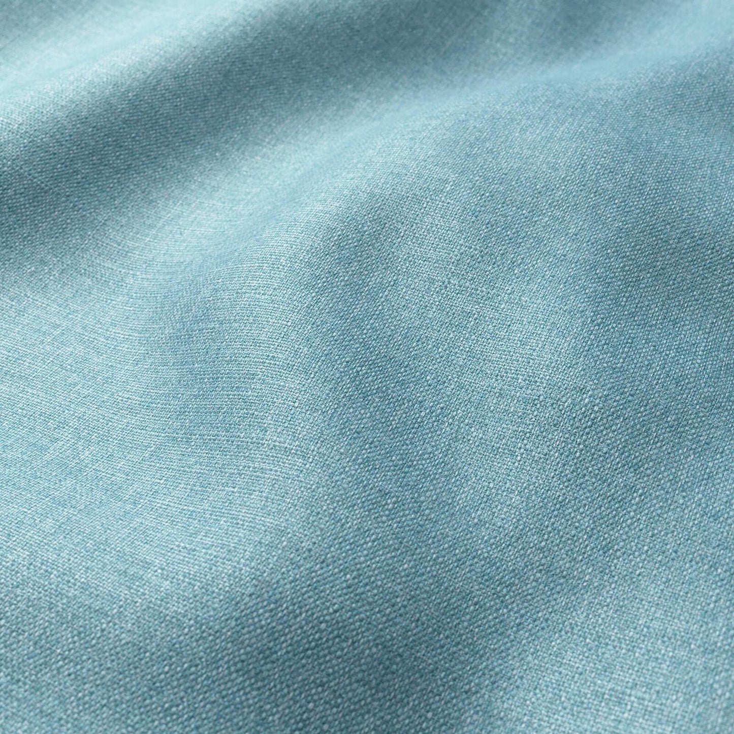 Close-up of light blue fabric with a fine weave and soft folds.