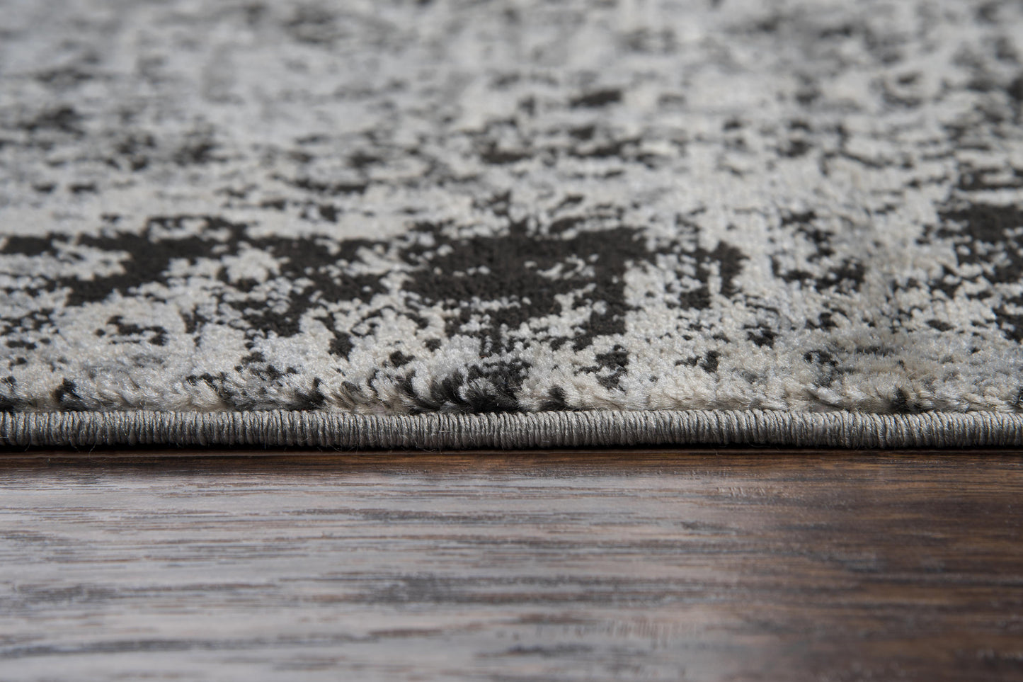 Transitional-style area rug in neutral tones, 5' x 7'.