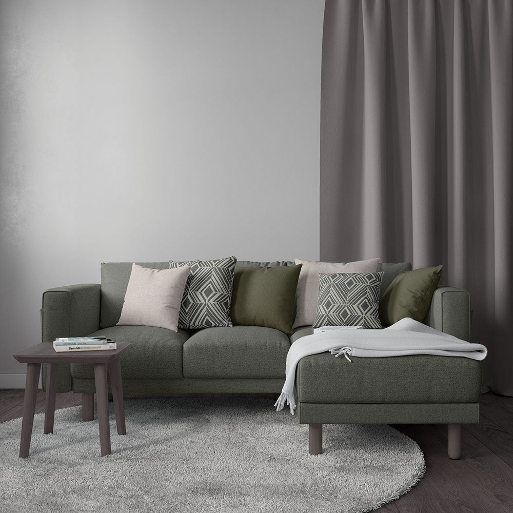 Olive green fabric sectional sofa with chaise, textured cushions, dark wood coffee table, light gray rug, contemporary style.