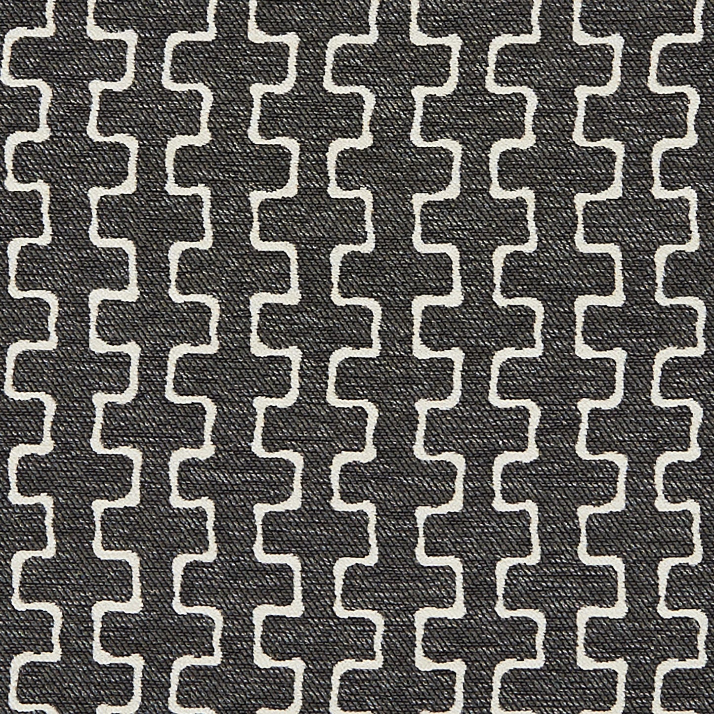 Charcoal fabric with white interlocking S-shaped chain motif, textured woven upholstery.