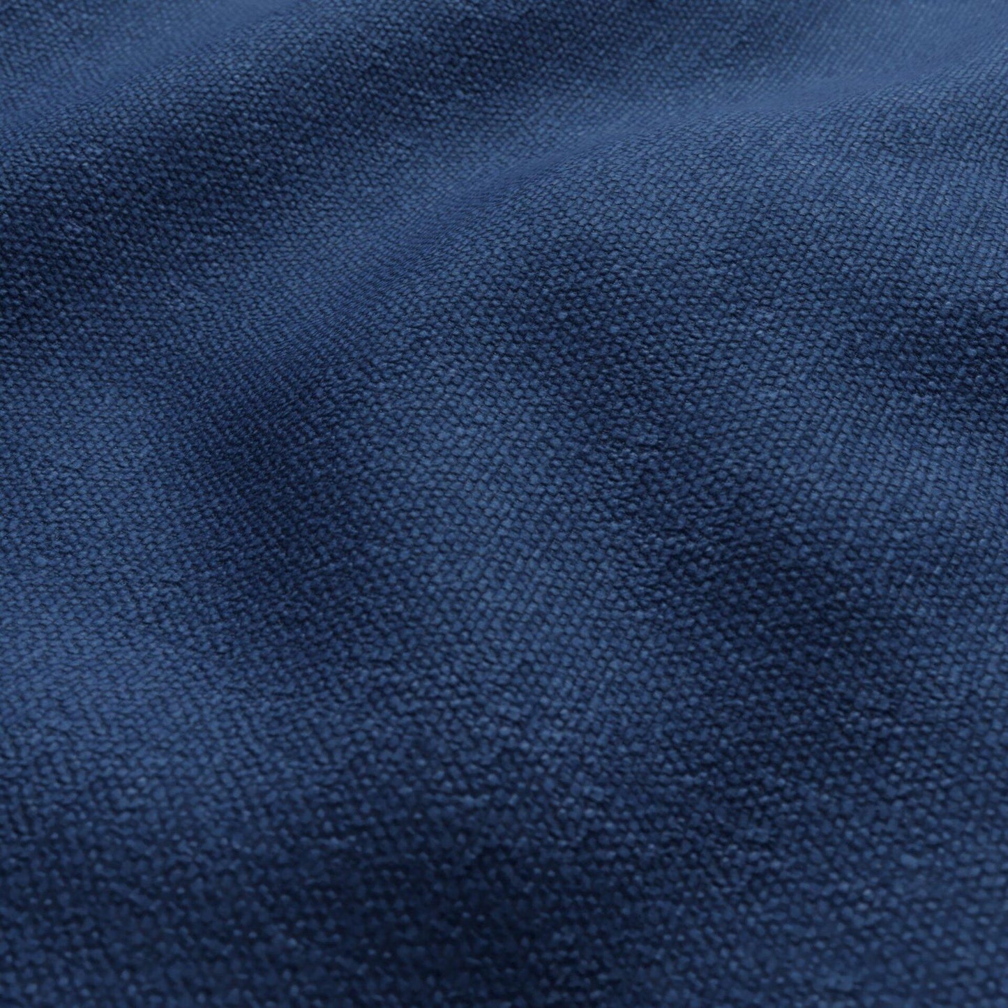 Close-up of navy blue textured outdoor fabric with chenille-style looped fibers.