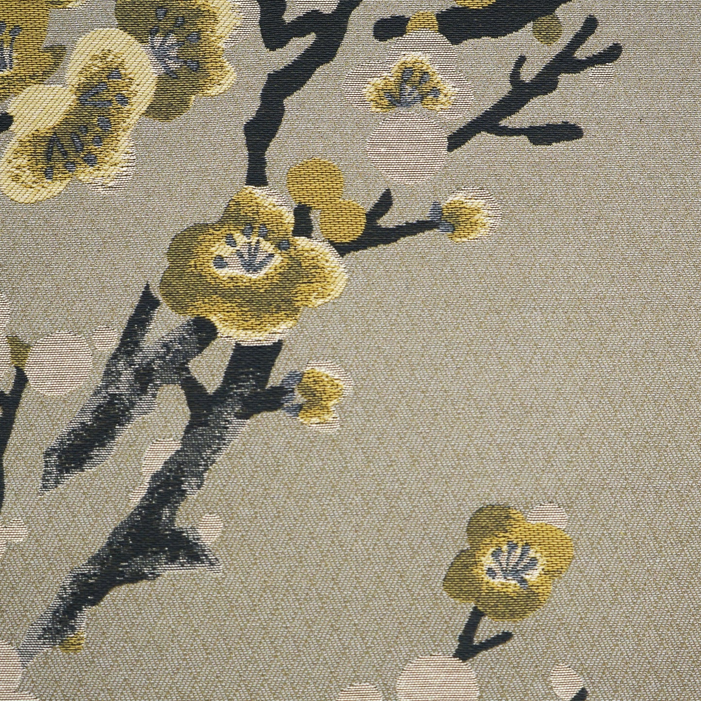 Beige jacquard fabric with black branches and yellow plum blossoms in a decorative floral tapestry.