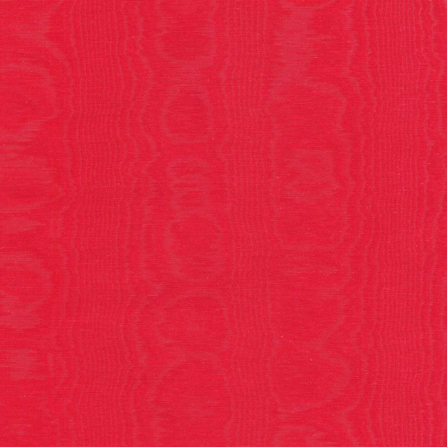 Close-up of red moire fabric with a subtle textured surface.