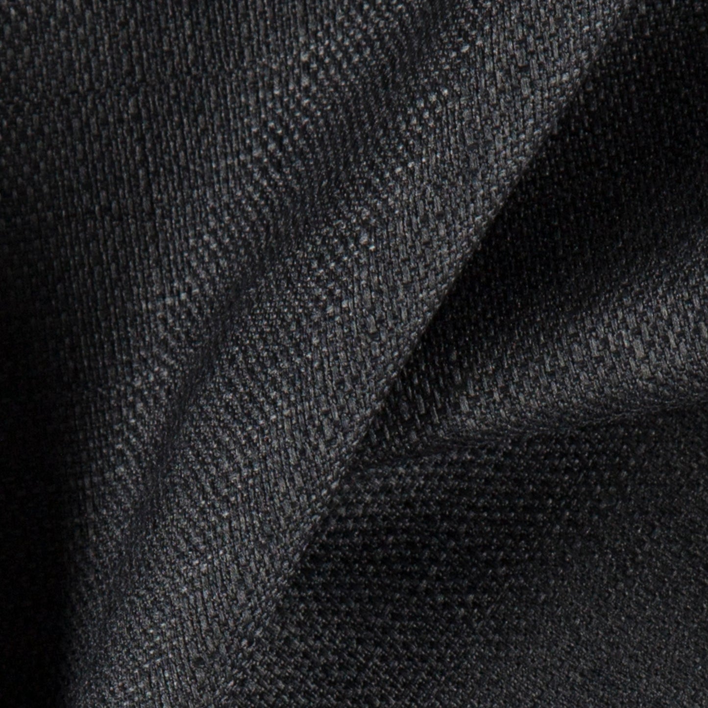 Dark charcoal linen-textured fabric close-up; textured, soft and durable weave for jackets or sweaters.