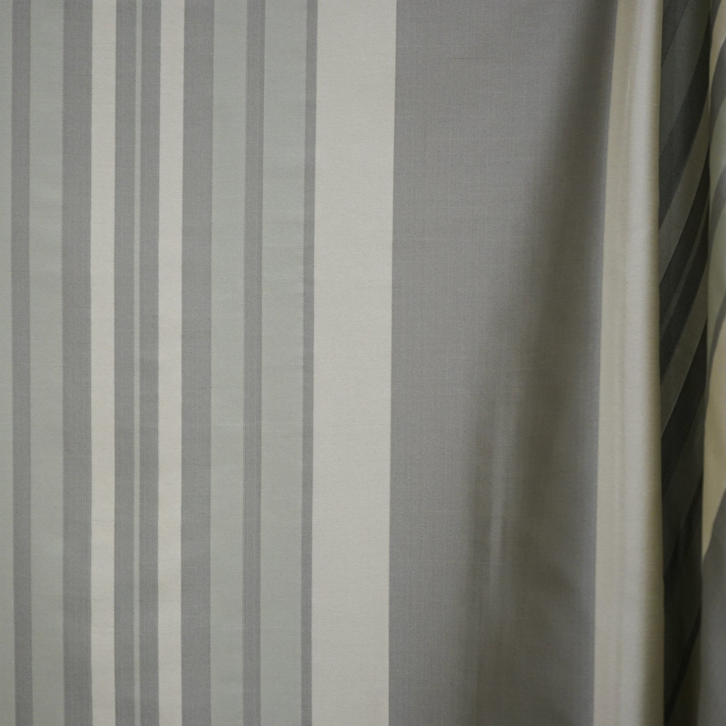 Grey and white vertical striped woven curtain fabric; modern neutral window drape.