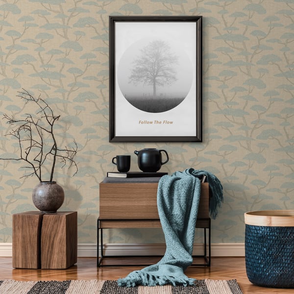 Cozy living room vignette with circular tree print, wooden console, black teapot, teal throw, bare-branch vase, and blue woven basket.