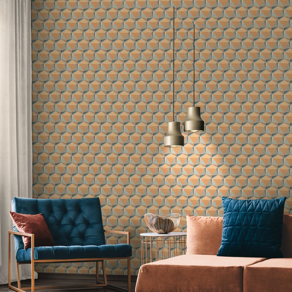 Modern living room featuring orange geometric wallpaper, a blue velvet tufted chair, peach sofa, glass side table, and gold pendant lights.
