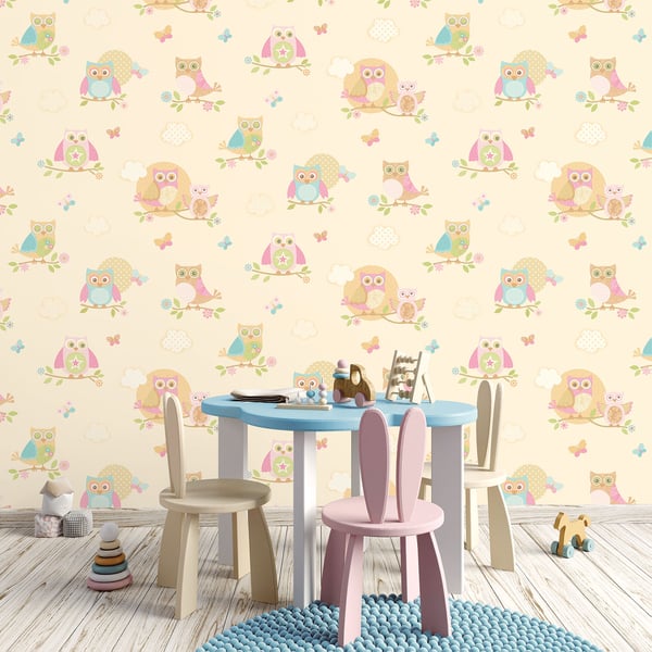 Pastel childrens playroom with round blue table, pastel chairs, bunny-ear seat, and owl wallpaper.