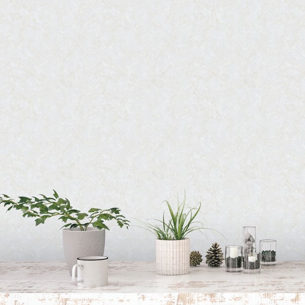 Wallpaper backdrop featuring a neutral decor scene: two potted plants on a rustic whitewashed table with a white mug, glass jars, and pinecones.