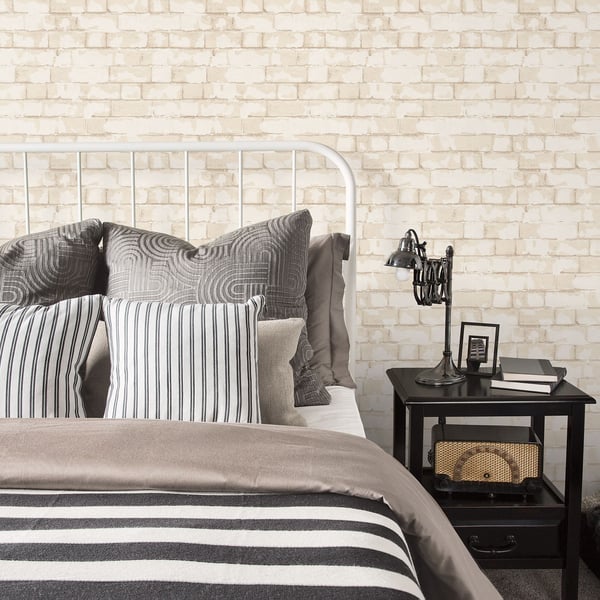 Cream brick wallpaper on a wall with a soft, vintage brick pattern.
