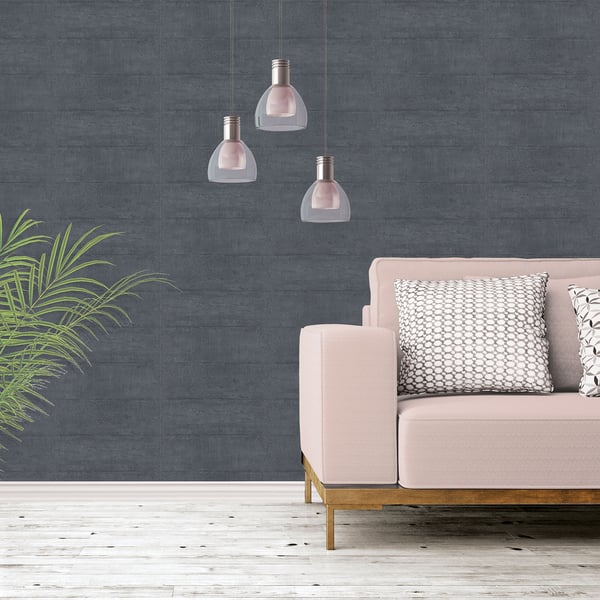Soft pink sofa with cushions against dark textured concrete wallpaper in silver grey, white floor, pink pendant lights, and a green plant.