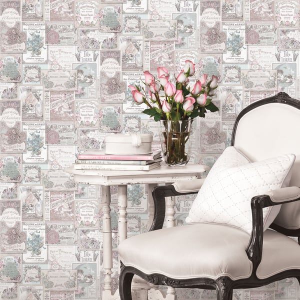 Pink wallpaper with vintage perfume-label motifs.