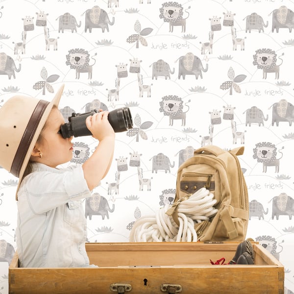Kid explorer with binoculars, tan safari hat, beige backpack with rope, beside a wooden crate against animal wallpaper.
