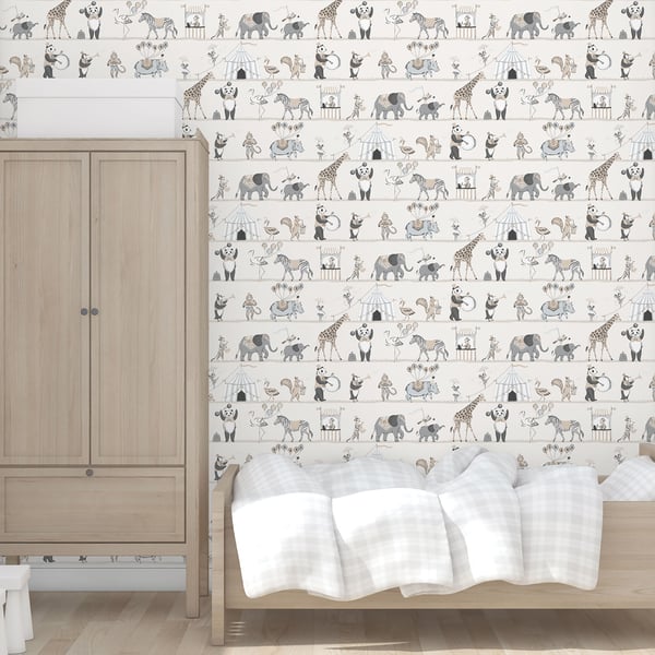 Light wood wardrobe beside a bed with a white blanket; soft gray animal wallpaper with giraffes and elephants.