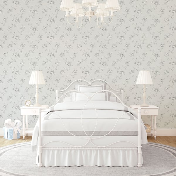 Wallpaper with a floral rose pattern in silver-grey tones on the wall.