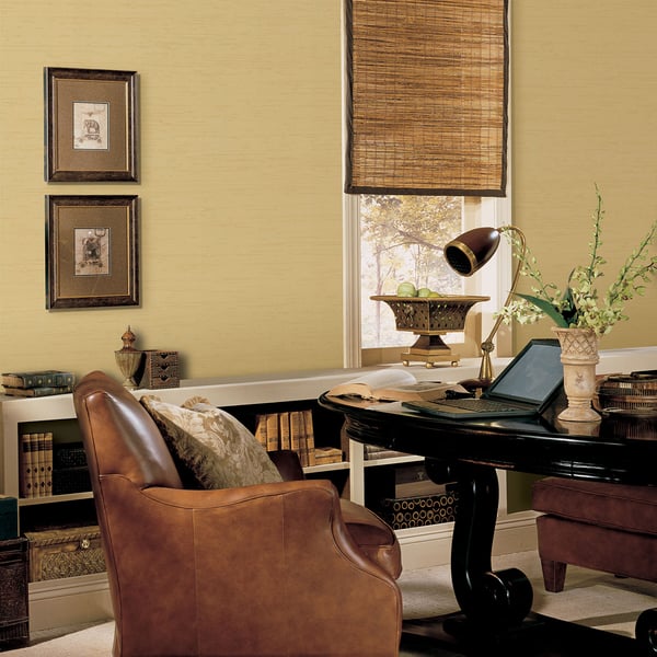 Gold silk-textured wallpaper on a wall.