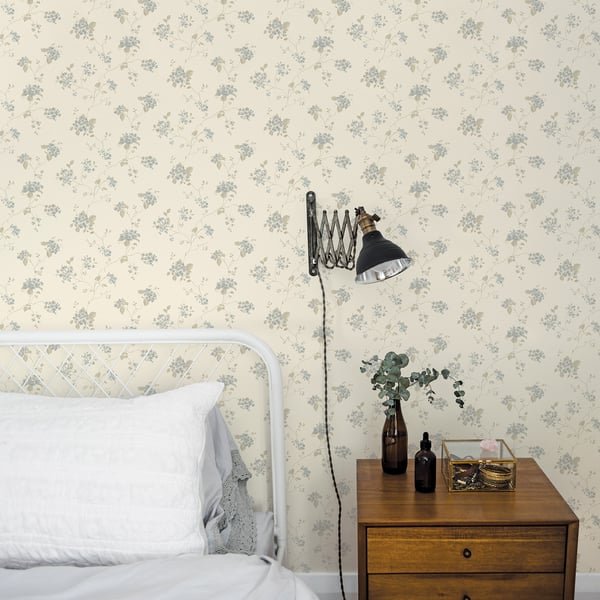 Cream wallpaper with lilac floral pattern on a beige background; subtle, delicate flowers.