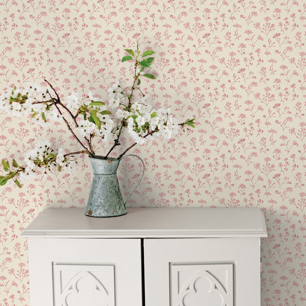 Cream wallpaper with a pink floral pattern.