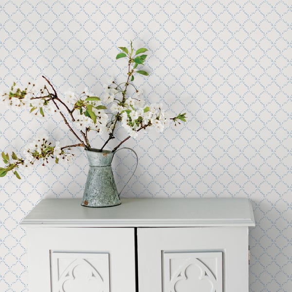 Blue wallpaper featuring a geometric floral pattern.