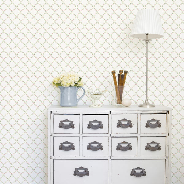 White wallpaper with a geometric floral pattern.