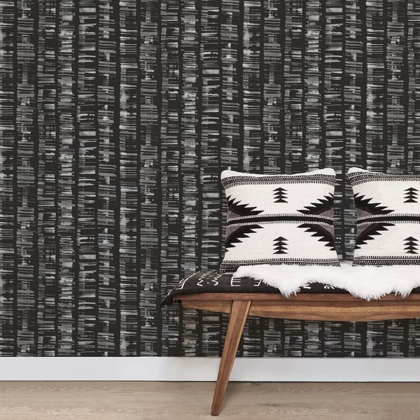Silver-grey wallpaper with an Aztec-inspired geometric pattern.