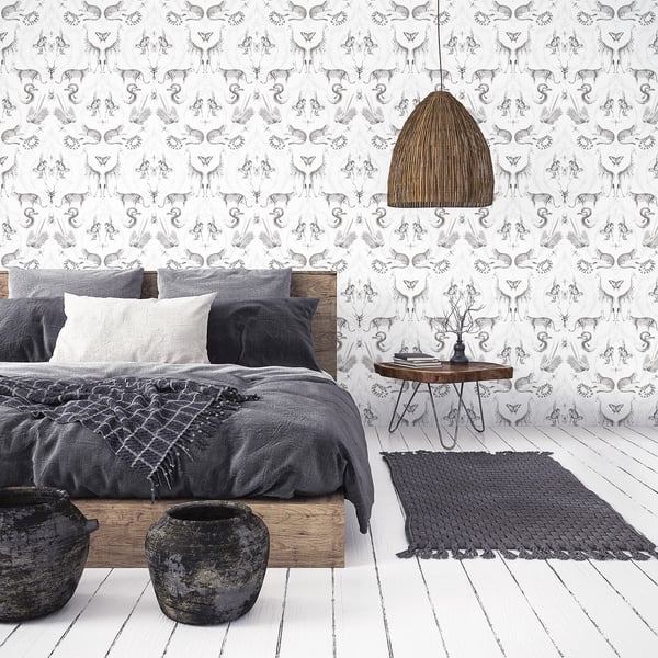 Bedroom with wooden bed, gray linen bedding, white/gray pillows, woven rattan pendant lamp, patterned wallpaper, dark rug.