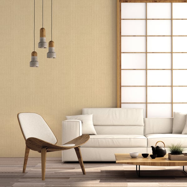 Beige living room with mid-century wood chair, white sofa, low wood coffee table, shoji screen and three pendant lights.