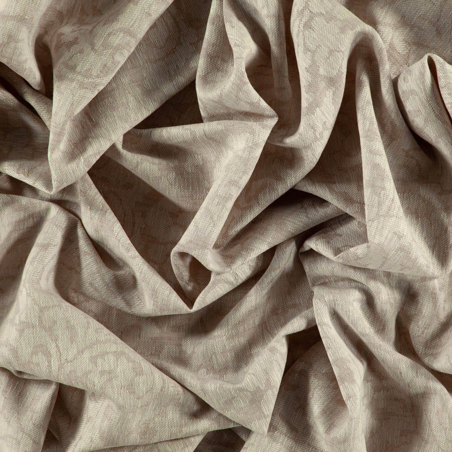 Beige jacquard damask fabric with subtle floral pattern and soft, flowing folds.