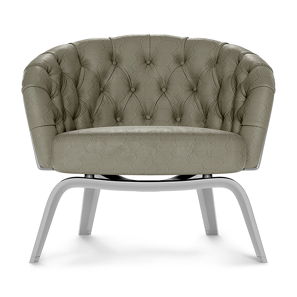 Olive-gray tufted fabric accent chair with buttoned hex pattern, rounded back, and white curved metal sled legs.